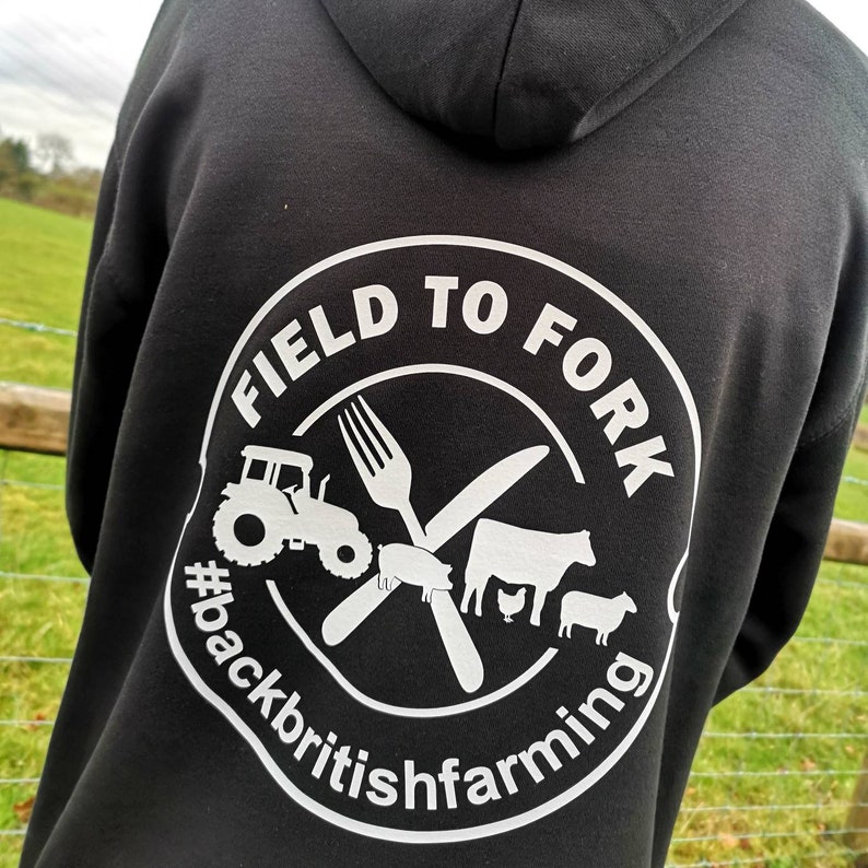 May include: Black hoodie with a white circle graphic that says "Field to Fork #backbritishfarming" with a tractor, fork, knife, pig, cow, chicken, and sheep.