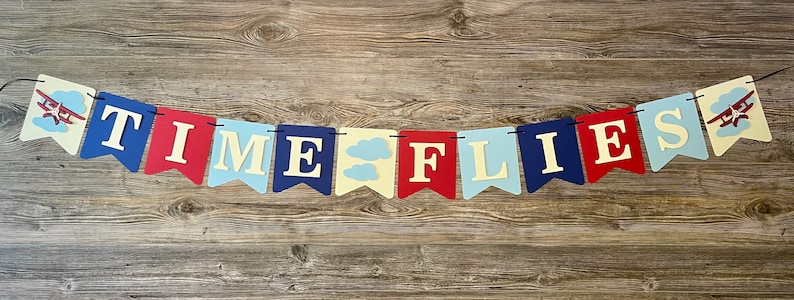 TIME FLIES banner option. Made on one ribbon with airplanes on the end flags and a cloud flag between words.