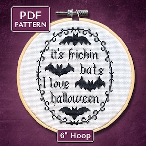 May include: A cross-stitch pattern in a 6-inch hoop with the text "it's frickin' bats I love Halloween" and bat illustrations. The design is in black thread on white fabric, with a decorative border. The PDF pattern is available.