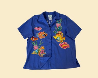 90s bedazzled fish shirt in size 1X by The Quacker Factory, vintage blue and rainbow women's 1990s blouse