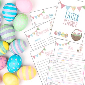 May include: Printable Easter planner with a pastel color scheme. The planner includes sections for to-do lists, activity plans, budget, menu, and recipes. The planner is decorated with pastel colored Easter eggs and a banner of flags.