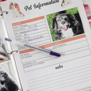May include: A white binder with a page open to a pet information form. The form has fields for pet name, date of birth, sex, weight, breed, and color. The form also has a section for important contacts and notes. A photo of a black and white dog is on the page.