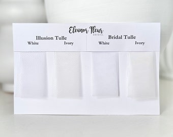 May include: A white display card labeled Eleanor Fleur Bridal featuring four fabric swatches. The left two are labeled Illusion Tulle in White and Ivory, while the right two are labeled Bridal Tulle in White and Ivory, showing distinct textures.