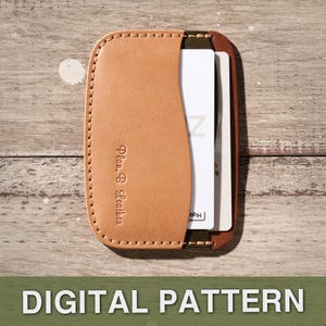 May include: A tan leather card holder with a curved design, stitched edges, and the text "Plan B Leather" embossed on the front. The holder contains white and brown cards. The words "DIGITAL PATTERN" are at the bottom.