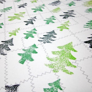 May include: White background with a repeating pattern of green and black stylized pine trees. The trees are printed in a textured style.