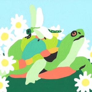 May include: A green turtle with a red and yellow shell sits on a bed of white daisies. A green dragonfly with white wings sits on the turtle's back.