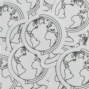 May include: A pile of white globe stickers with black outlines. The globes are drawn in a simple style with continents and oceans.