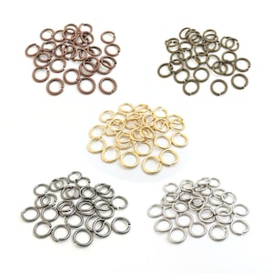 May include: Assortment of jump rings in four different colours: gold, silver, bronze, and antique brass. The jump rings are small and round, and they are perfect for jewellery making or other crafts.