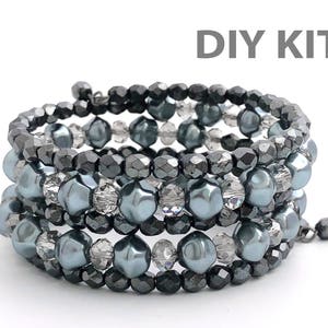 May include: DIY kit for a multi-strand bracelet featuring gray and silver beads. The bracelet is made with multiple strands of beads, including round, faceted, and pearlescent beads.