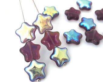 May include: A strand of iridescent star-shaped glass beads in shades of purple and gold. The beads are strung on a silver wire.