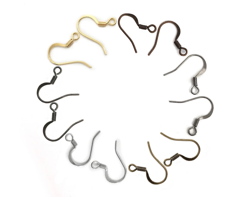 May include: Assortment of earring hooks in gold, silver, and bronze. The hooks are arranged in a circle on a white background.