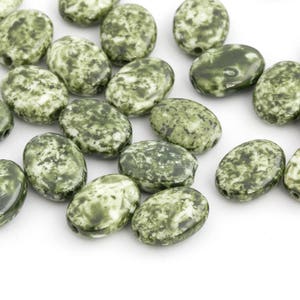 May include: A collection of oval-shaped beads with a mottled green and white pattern. The beads are smooth and glossy, with a hole drilled through each for stringing. These beads are suitable for jewelry making and crafting.