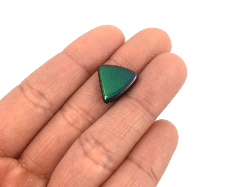 May include: A triangular iridescent green gemstone with a black edge.