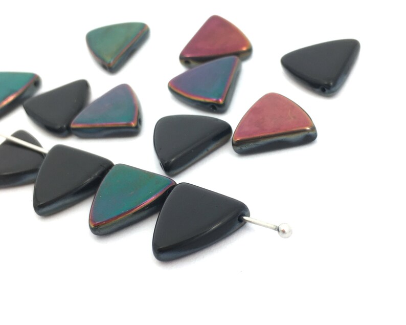 May include: Assortment of iridescent triangle shaped glass beads in black, green, and red. The beads are strung on a silver wire.
