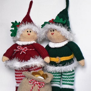May include: Two knitted elf dolls, one in red and white and one in green and white, holding a brown sack filled with gold coins. The elf dolls have white fur trim and are wearing knit hats.