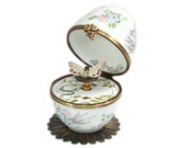 Waltz butterfly music box. Hand-painted fine Limoges porcelain egg. Waltz Flowers melody. Handcraft in France.