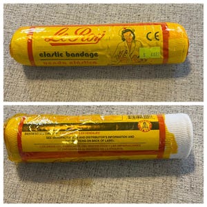 May include: Yellow and red elastic bandage roll with the text "Le Roy" and "elastic bandage". The packaging features an illustration of a nurse and the text "venda elástica".