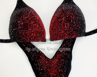 May include: Black and red competition bikini with a gradient design. The bikini is covered in rhinestones. The text "Amnesia Shop by Alyona Konstantinova" is printed on the bottom of the bikini.