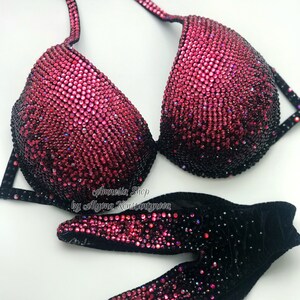 May include: A black and pink sequined bikini top with a gradient of pink to black sequins. The bikini top is made of a black fabric with a velvet texture. The bikini top is decorated with a large number of small, round sequins. The bikini top is designed for competition and is a popular choice for figure and bikini competitions.