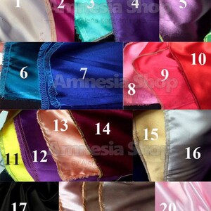 May include: A swatch card with 20 different colors of satin fabric. The swatches are numbered 1 through 20. The fabric colors include white, beige, pink, red, purple, blue, green, yellow, and black.