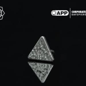 May include: A silver triangle-shaped body jewelry piece with a textured surface.