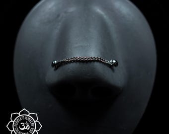 May include: A silver nose chain with two small silver balls on either end. The chain is made of a delicate, linked design.