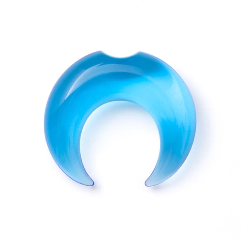 May include: A light blue crescent moon shaped glass ring.