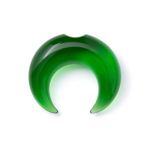 May include: A green glass crescent moon shaped ear gauge.