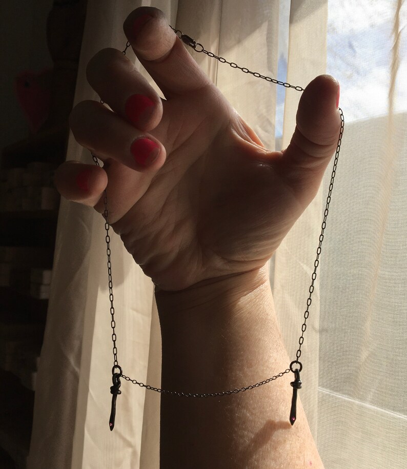 symmetrical necklace double dagger pendant rubies blackened silver camille hempel design two daggers