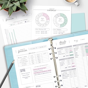 May include: A blue and white planner with the title "Objectif Financier" (French for "Financial Objective") and a table with financial data. The planner includes sections for budgeting, savings, and expenses.