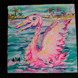 Sunset made white swan to appear pink