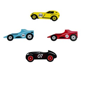 May include: Four toy racing cars in different colours and designs. A yellow car with the number 88, a blue car with the number 88, a red car with the number 17, and a black car with the number 07.