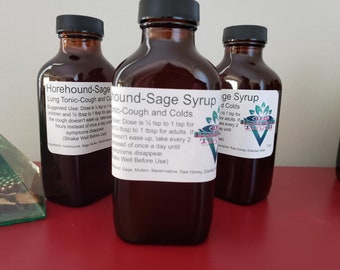 May include: Three brown glass bottles with labels for "Horehound-Sage Lung Tonic-Cough and Colds", "Hound-Sage Syrup Tonic-Cough and Colds", and "Sage Syrup for Colds". The bottles are on a red surface.