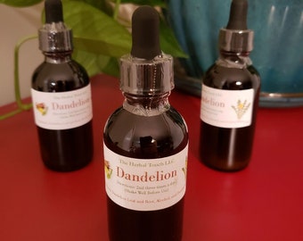 May include: Three glass bottles with dropper tops filled with a dark liquid. The bottles are labeled "Dandelion" and "The Herbal Touch LLC".
