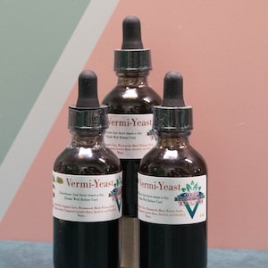 May include: Three dark brown glass bottles with dropper tops, labeled "Vermi-Yeast" and instructions for use. The bottles are sitting on a light blue surface.