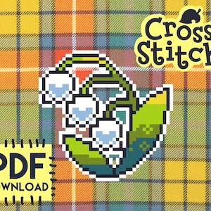 May include: Cross stitch pattern for a bouquet of white lily of the valley flowers with green leaves. The pattern is in a pixelated style and is available as a PDF download.