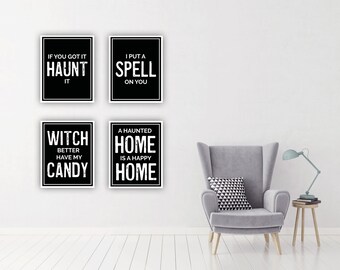 May include: Four black and white framed prints with Halloween-themed text. The prints are hung on a white wall. The text on the prints reads: "If you got it haunt it", "I put a spell on you", "Witch better have my candy", and "A haunted home is a happy home".
