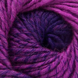 May include: A close-up of a ball of purple and dark purple yarn. The yarn is soft and fluffy, and it is perfect for knitting or crocheting.
