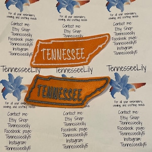 May include: Embroidered Tennessee state patches in orange and gray, with the state name stitched in white. The patches are surrounded by text and floral graphics, promoting embroidery and crafting supplies.