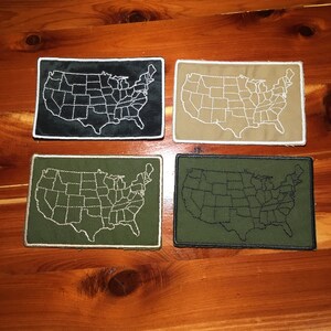 May include: Four embroidered patches of the United States map. The patches are in black, tan, green, and dark green. The state lines are white on the black and tan patches, and black on the green patches.