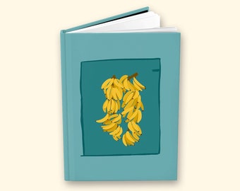 Puede incluir: Un libro de color turquesa con una ilustración cuadrada de un grupo de plátanos amarillos. El libro está ligeramente abierto, revelando páginas blancas. La ilustración del plátano está sobre un fondo turquesa más oscuro.