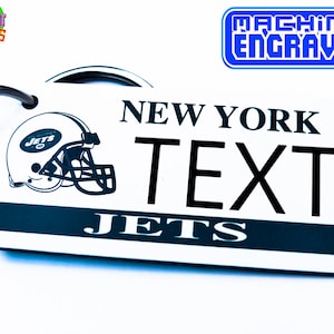 May include: White keychain with a black and white New York Jets logo, the words "New York Jets" and the text "TEXT".