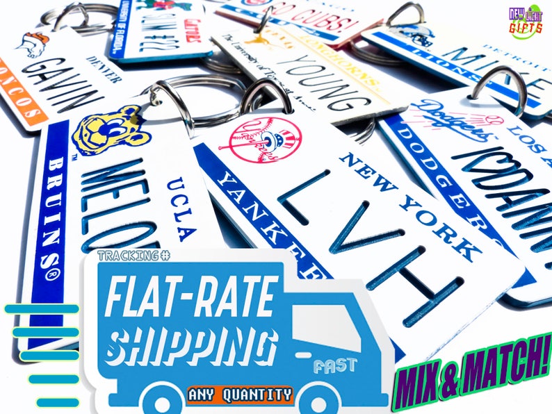 May include: A collection of personalized license plate keychains with various team logos and names, including Bruins, Dodgers, Yankees, Cubs, and more. The keychains are white with blue lettering and logos. The keychains are displayed on a blue and white background with the text "FLAT-RATE SHIPPING" and "MIX & MATCH!"