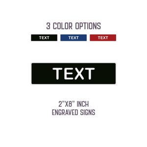 May include: Image of engraved signs with the text "TEXT" in white on a black background. The image shows three color options: black, blue, and red. The signs are 2" x 8" inches.
