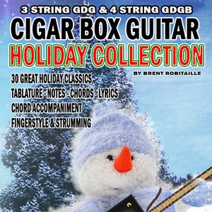 Puede incluir: Un muñeco de nieve con gorro y bufanda azules sostiene una guitarra de caja de cigarros. La guitarra es marrón con herrajes dorados. El texto en la imagen dice "Cigar Box Guitar Holiday Collection" y enumera características.