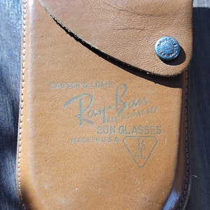 Camel brown supple leather case embossed with Bausch & Lomb
Ray-Ban. Reg. U.S. Pat. Off.
Sun glasses
Made in U.S.A.