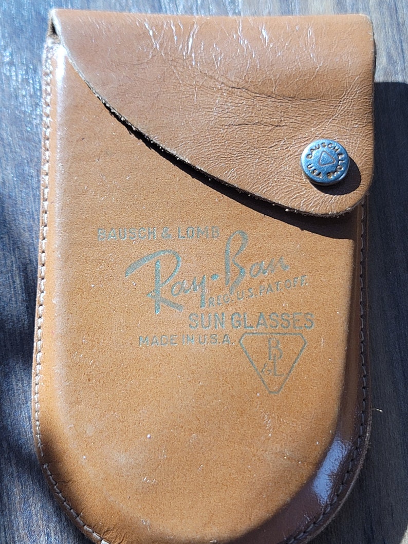 Camel brown supple leather case embossed with Bausch & Lomb
Ray-Ban. Reg. U.S. Pat. Off.
Sun glasses
Made in U.S.A.