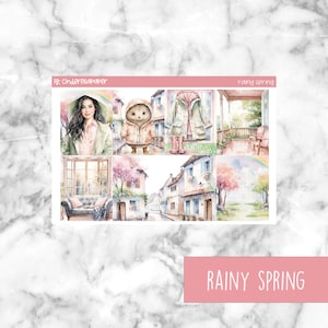 Puede incluir: Un conjunto de 6 pegatinas para planificador con una ilustración de acuarela de un día de primavera lluvioso. Las pegatinas incluyen una mujer con el pelo largo y oscuro, un oso con un impermeable, un impermeable colgado de un gancho, un porche con dos sillas, una calle con casas y cerezos en flor, y un paisaje con un arcoíris.