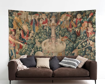 May include: A tapestry depicting a scene from the Unicorn Tapestries, featuring a group of people in medieval clothing gathered around a fountain with a unicorn in the background. The tapestry is woven with intricate details and vibrant colors, including shades of red, blue, green, and gold.