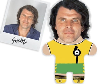 May include: A personalized plush toy with a photo of a person's face on the head. The toy is wearing a yellow and green soccer uniform with a black number 6 and a soccer ball on the chest. The toy has black and white striped socks and black shoes.
